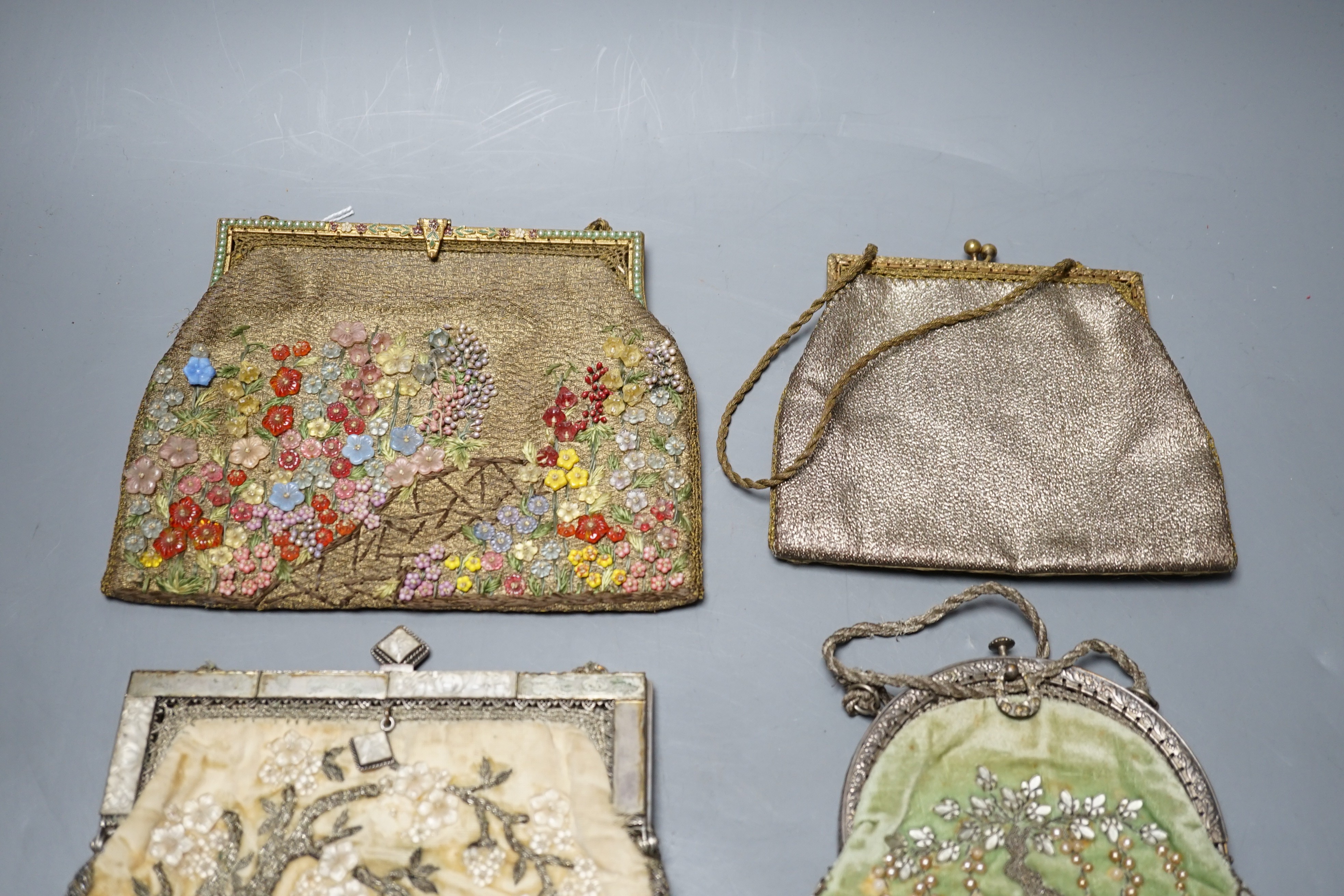 Four hand made evening bags with applice designs, a chain stitch clutch bag and a small bead work purse, largest 16 cms high